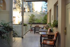 an outdoor patio with tables and chairs and plants at Self-service Hotel Ostaš Praha in Prague