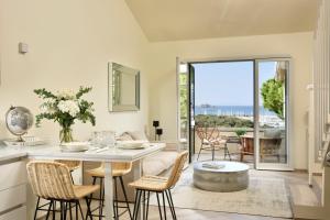 a kitchen and dining room with a table and chairs at Punta Ala Sea View Apartments in Punta Ala