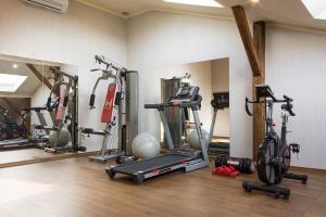 a gym with a bunch of exercise bikes in a room at Grand Hotel in Krakow