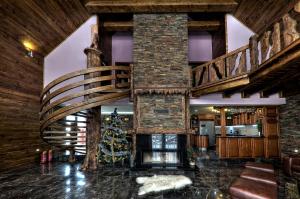a lobby with a christmas tree and a spiral staircase at Mountain Resort Ždiar - Chalets in Ždiar