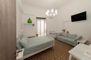 a living room with a bed and a couch at La Serva Padrona in Taranto