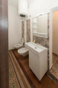 a bathroom with a sink and a toilet and a mirror at La Serva Padrona in Taranto +32 photos