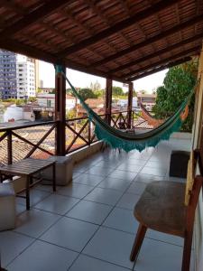 a hammock on the roof of a house at Pousada Innova in Natal