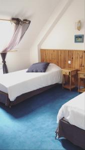 Ein Bett oder Betten in einem Zimmer der Unterkunft La Ferme de la Maugerie