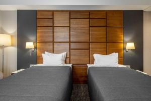 Postel nebo postele na pokoji v ubytování CITYHOTEL