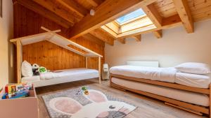 ein Kinderzimmer mit 2 Betten und einem Dachfenster in der Unterkunft VIU Hotel Villars in Villars-sur-Ollon