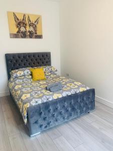 a bed in a bedroom with a blue bed frame at Sandleigh Apartment in Scarborough
