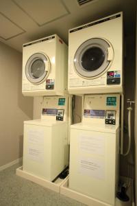 two washing machines are on display in a room at Sotetsu Fresa Inn Higashi Shinjuku in Tokyo