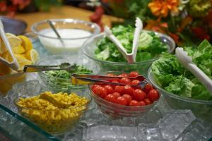 a table topped with bowls of tomatoes and vegetables at Sotetsu Fresa Inn Higashi Shinjuku in Tokyo
