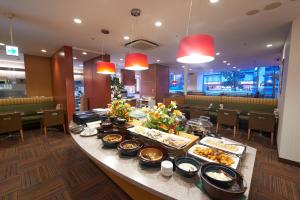 a buffet of food on a table in a restaurant at Sotetsu Fresa Inn Higashi Shinjuku in Tokyo