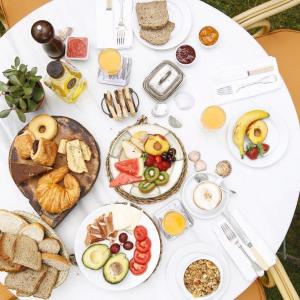 a white table topped with plates of breakfast foods at Hotel Punta Sur in Tarifa