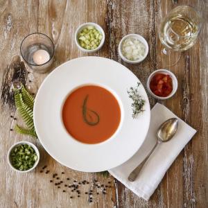 a bowl of soup on a wooden table at Hotel Punta Sur in Tarifa