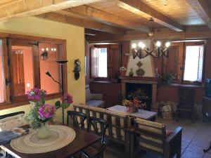 a dining room with a table and chairs and a fireplace at CASA DEOGRACIAS in Veguellina de Órbigo