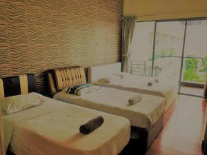 een slaapkamer met 2 bedden en een raam bij Borneo Coastal Residence @ IMAGO Mall in Kota Kinabalu
