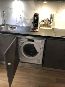 een keuken met een wasmachine en een wastafel bij A&F Apartment Padova Piazza Garibaldi in Padua