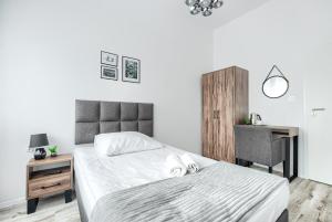 a bedroom with a bed and a desk and a chair at Studencki Dom Marynarza Korab in Szczecin