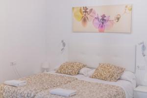 エル・プエルト・デ・サンタマリアにあるApartamentos casa palacioのベッドルーム1室(ベッド2台付)が備わります。壁に絵が描かれています。