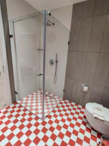 a bathroom with a shower and a toilet at HOLM Boutique & SPA - IK Collection in St. Julianʼs
