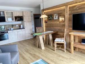 a living room with a table and a tv at Ferienwohnungen Am Kranzbach FeWo1 in Krün +45 photos