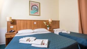 Postel nebo postele na pokoji v ubytování Hotel Trastevere