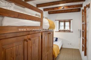 a bedroom with two bunk beds and a small bed at Casa Er Os by Totiaran in Baqueira-Beret