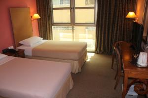 Posteľ alebo postele v izbe v ubytovaní Classique Hotel
