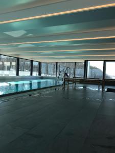 a swimming pool with a bench in a building at Magnolia in Ostseebad Sellin