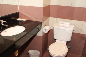 a bathroom with a toilet and a sink at Classique Hotel in Singapore