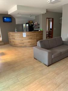 a living room with a couch and a counter at Pinheiros Hotel in Goiânia