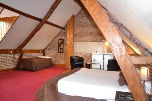 a attic room with a bed and a kitchen at Le Domaine des Cigognes in Ennevelin +54 photos