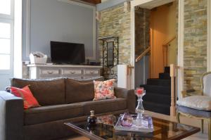 a living room with a couch and a table at Villa Moncoeur in Le Blanc