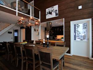 a dining room with a wooden table and chairs at Ottsjö Bear Lodge in Ottsjö