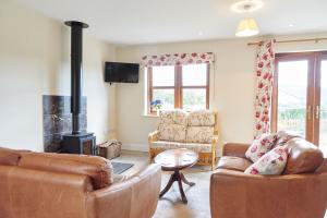 a living room with two couches and a fireplace at Finest Retreats - Quail's Nest Cottage in Edlingham