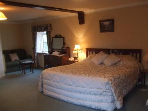 En eller flere senger på et rom på Richmond Country House & Restaurant
