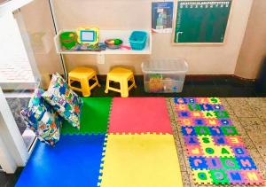 a toy room with a table and a desk at Hotel Express Canoas in Canoas