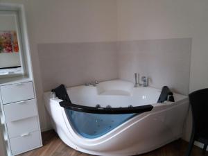 a white bath tub in a room with a table at Pigneto Square Home in Rome