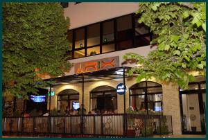 a restaurant with people sitting inside of a building at Pensiunea Rix Rooms in Focşani