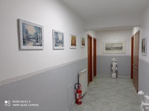 a hallway with pictures on the walls of a building at Hotel Alloggio Del Conte in Naples
