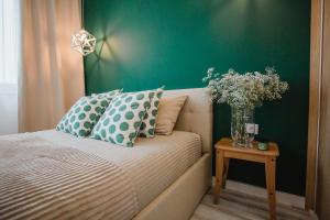 sypialnia z łóżkiem i wazonem kwiatów na stole w obiekcie W&K Apartments - Green Suite w Koszalinie