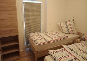 2 Einzelbetten in einem Zimmer mit Fenster in der Unterkunft Ferienwohnung Riverfront in Kappeln