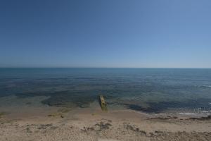 a pole sticking out of the water on a beach at Dar Corniche La Marsa (Adults Only) in La Marsa