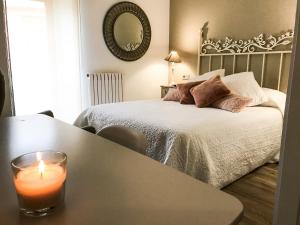 a room with a bed with a candle on a table at La Casona de Alútiz & Bodega in Samaniego