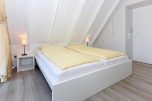Säng eller sängar i ett rum på Ferienhaus Nordlicht