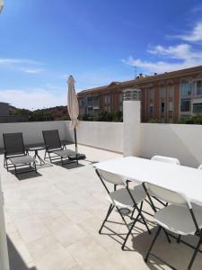 a group of chairs and tables on a roof at Sosiego Home in Puerto de Mazarrón