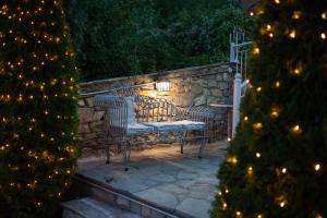 a bench with a light on a stone wall at Dandy Villas Nymfaio - Snow Fairy - Sauna in Nymfaio