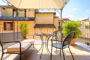 a patio with a table and chairs on a balcony at Hotel Touring in Bologna