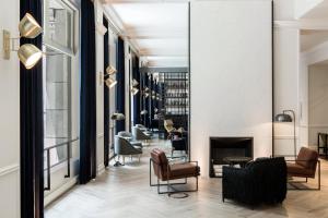 a lobby with chairs and a fireplace at Kimpton Gray Hotel Chicago, an IHG Hotel in Chicago
