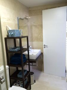 a bathroom with a sink and a toilet and a mirror at Felix Saenz by Luma in Málaga