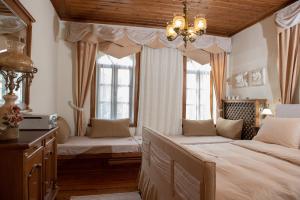 a bedroom with two beds and two windows at Dandy Villas Nymfaio - Snow Fairy - Sauna in Nymfaio