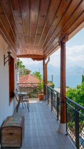 a balcony with a table and a bench and the ocean at Antalya Inn Hotel in Antalya